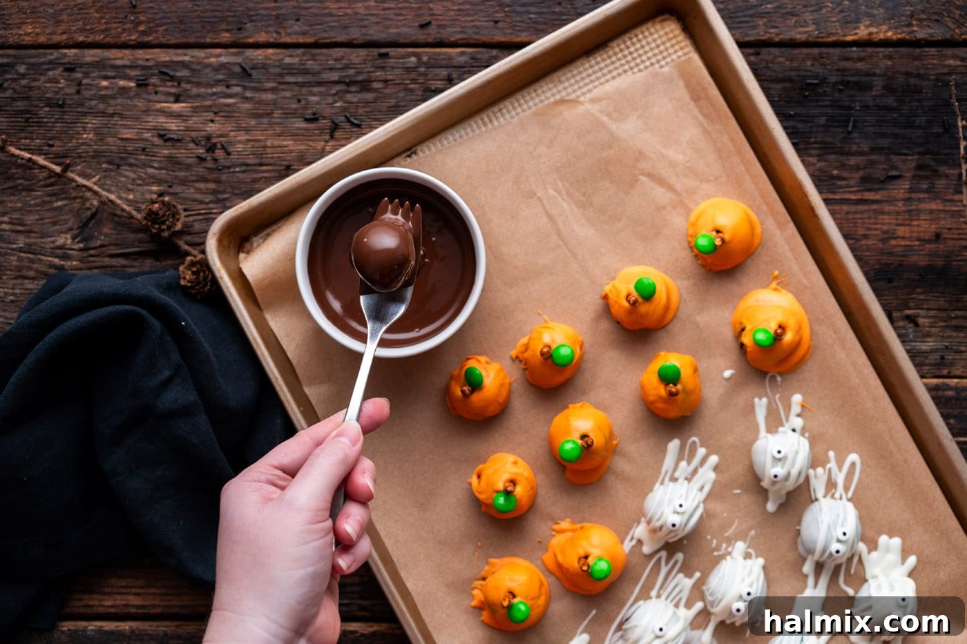 Hauntingly Delicious Oreo Truffles 15 dipping oreo truffle into chocolate