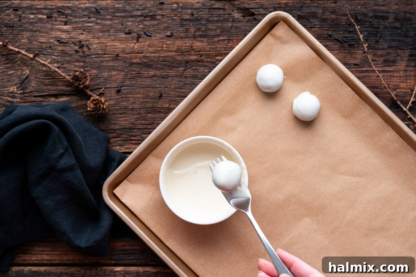 Hauntingly Delicious Oreo Truffles 10 dipping oreo truffle into white chocolate