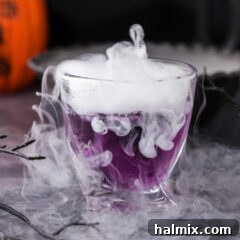Close up photo of a smoky Purple People Eater Cocktail