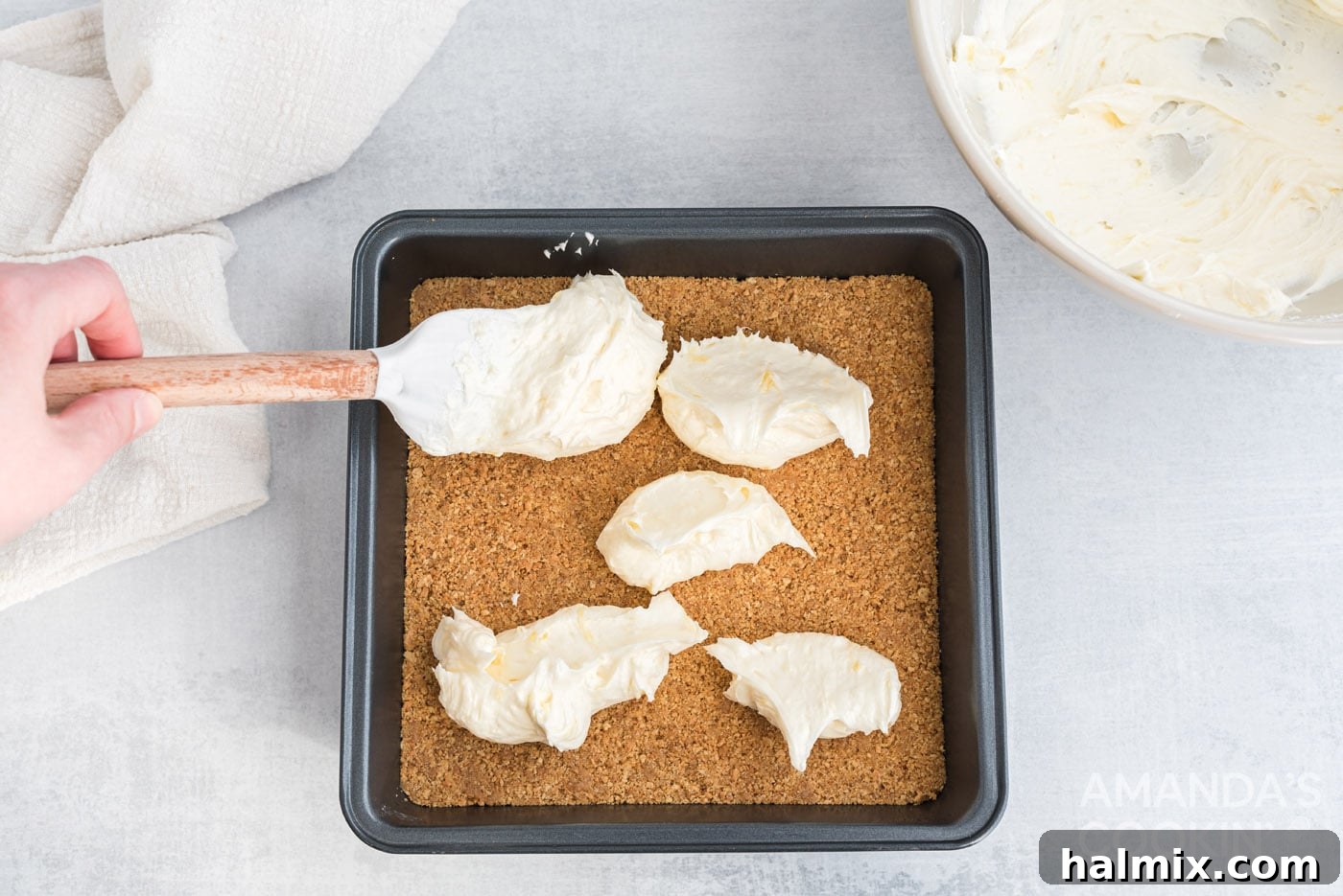 Tropical Pineapple Bliss 8 The smooth cream cheese and pineapple mixture being spread evenly over the graham cracker crust.