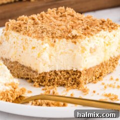 Pineapple Dream Dessert slice with a bite taken out, showing its creamy texture.