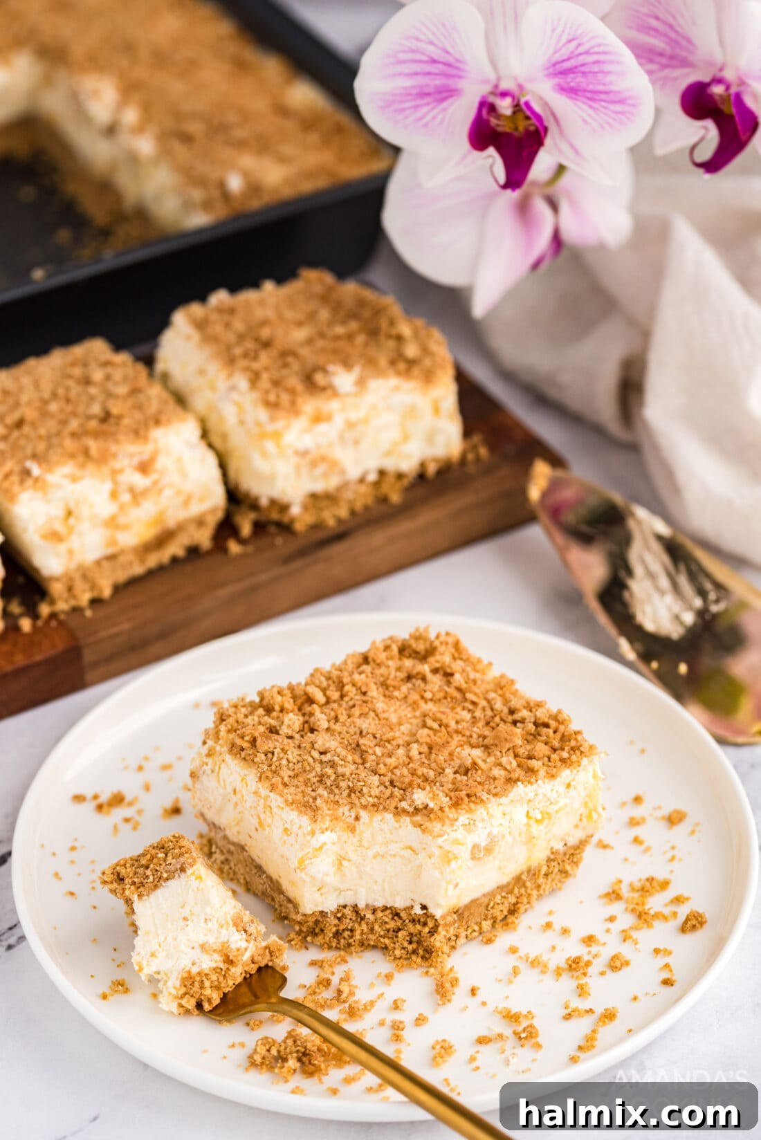 Single Slice of Pineapple Dream Dessert A perfectly portioned slice of Pineapple Dream Dessert resting on a simple white plate, ready to be enjoyed.