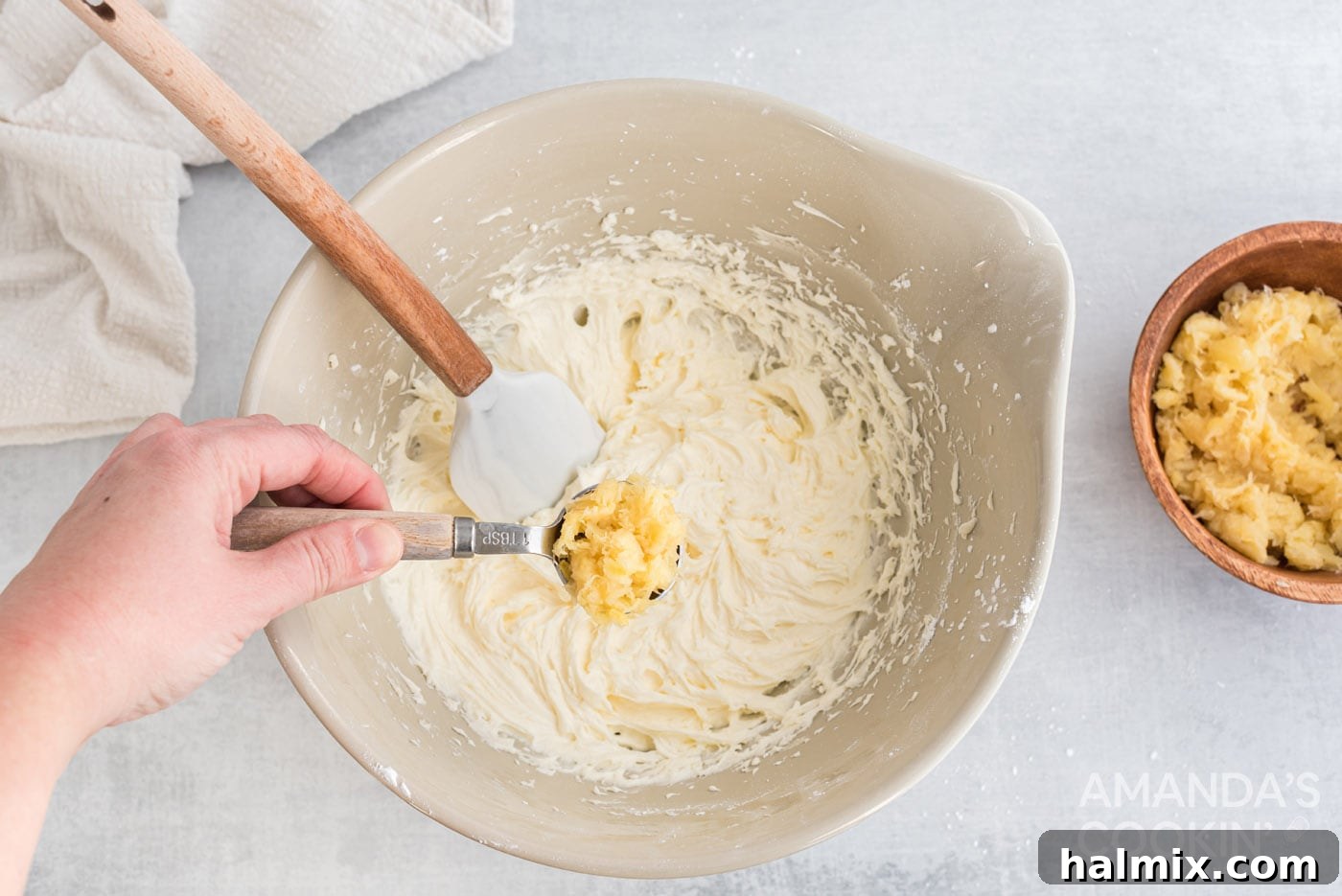 Tropical Pineapple Bliss 7 A rubber spatula gently stirring a tablespoon of drained crushed pineapple into the cream cheese mixture.