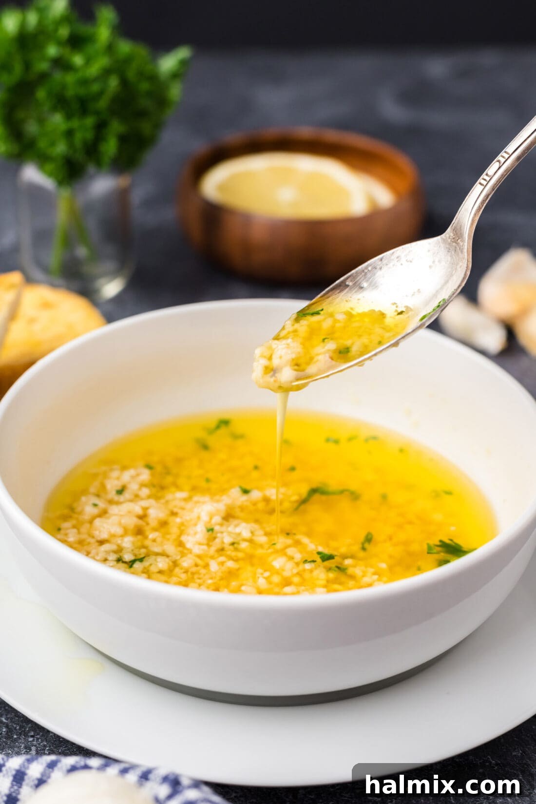 Irresistible Garlic Butter Sauce 11 A spoon drizzling rich, glossy Garlic Butter Sauce into a serving bowl, showcasing its perfect consistency.