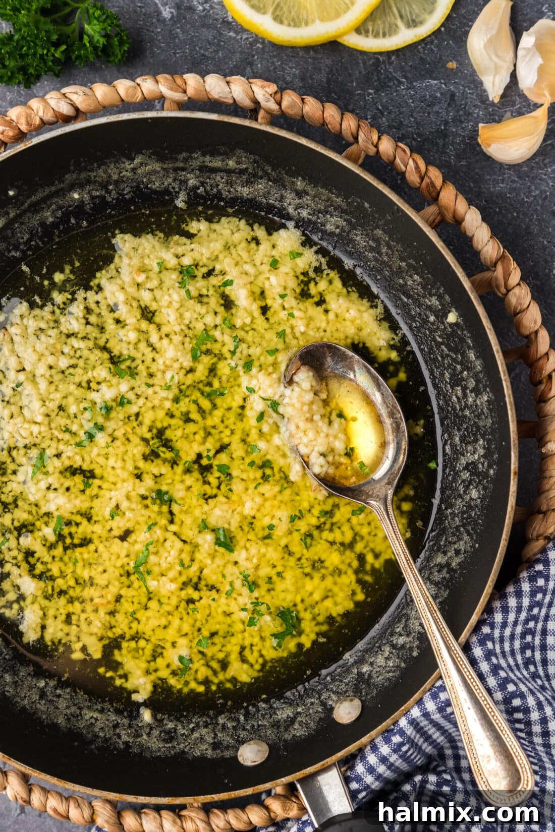 Irresistible Garlic Butter Sauce 3 A skillet filled with bubbling, golden Garlic Butter Sauce, a spoon resting in it, ready to be served.