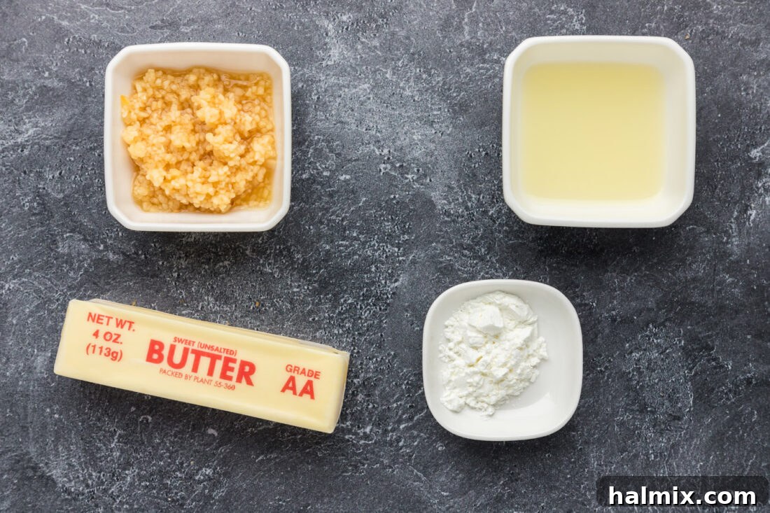 Irresistible Garlic Butter Sauce 4 Individual ingredients neatly laid out on a surface, including a stick of butter, minced garlic, a lemon, and a small bowl of cornstarch.