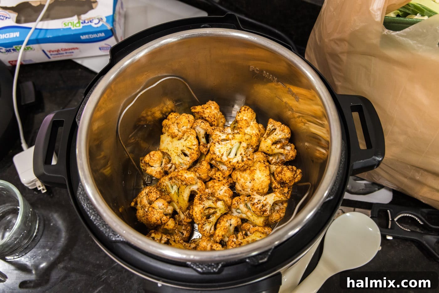 Effortless Instant Pot Cauliflower 8 Seasoned cauliflower florets carefully arranged on the trivet inside the Instant Pot, ready for the lid to be secured and cooking to begin.