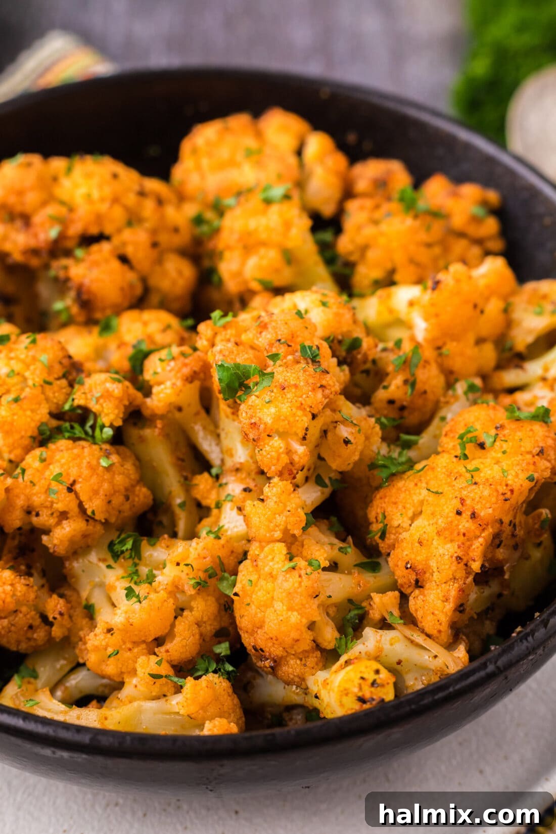 Effortless Instant Pot Cauliflower 10 A vibrant close-up of perfectly seasoned Instant Pot Cauliflower in a bowl, showcasing the rich colors of the spices and the tender texture of the florets.