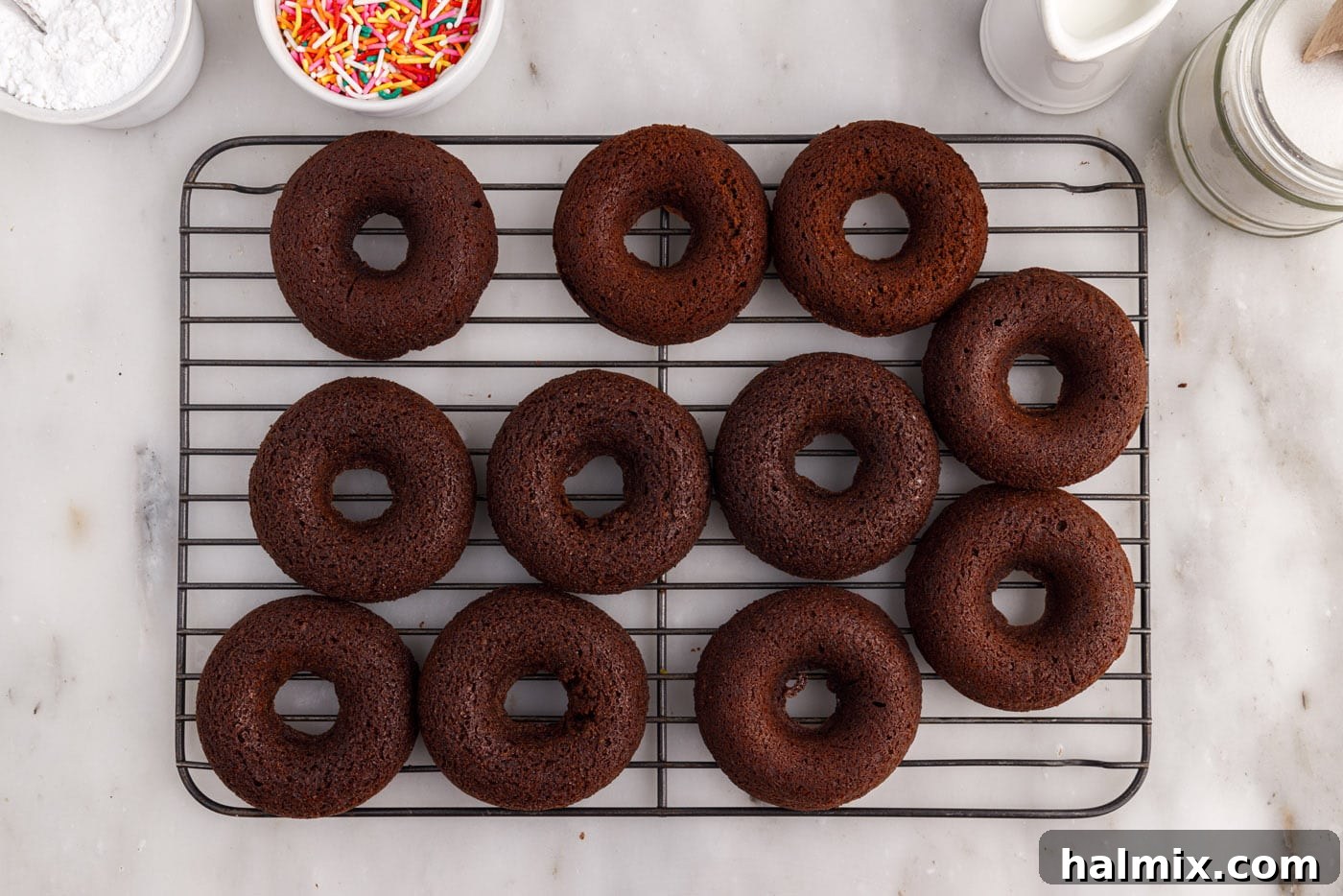 Baked chocolate donuts cooling on a wire rack