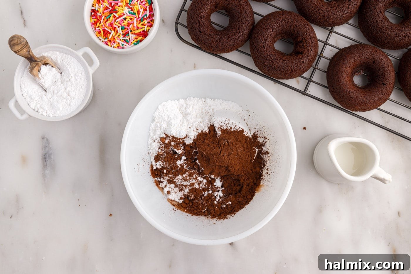 Cocoa powder, powdered sugar, and milk in a bowl for the chocolate glaze