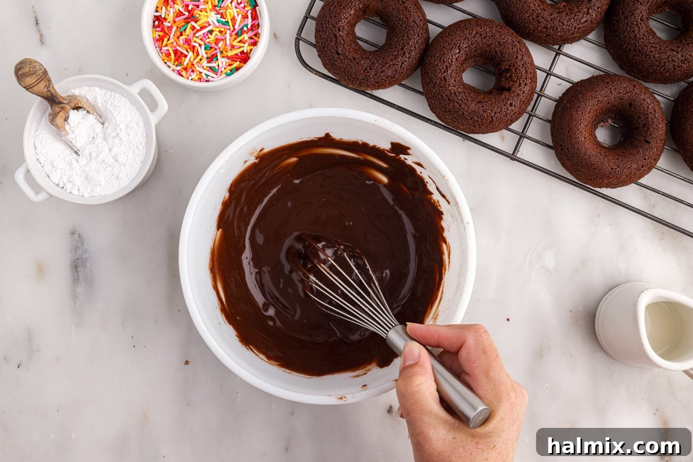 Whisking the chocolate glaze in a bowl until smooth