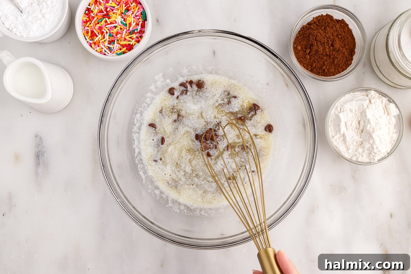 Whisking melted butter and chocolate chips in a bowl until smooth