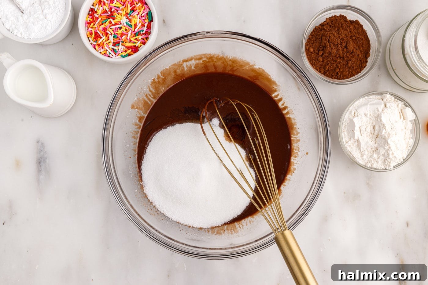 Whisking granulated sugar into the chocolate mixture