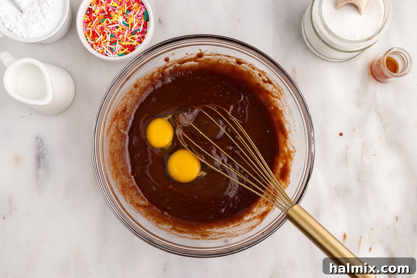 Whisking eggs into the chocolate mixture for the bronut batter