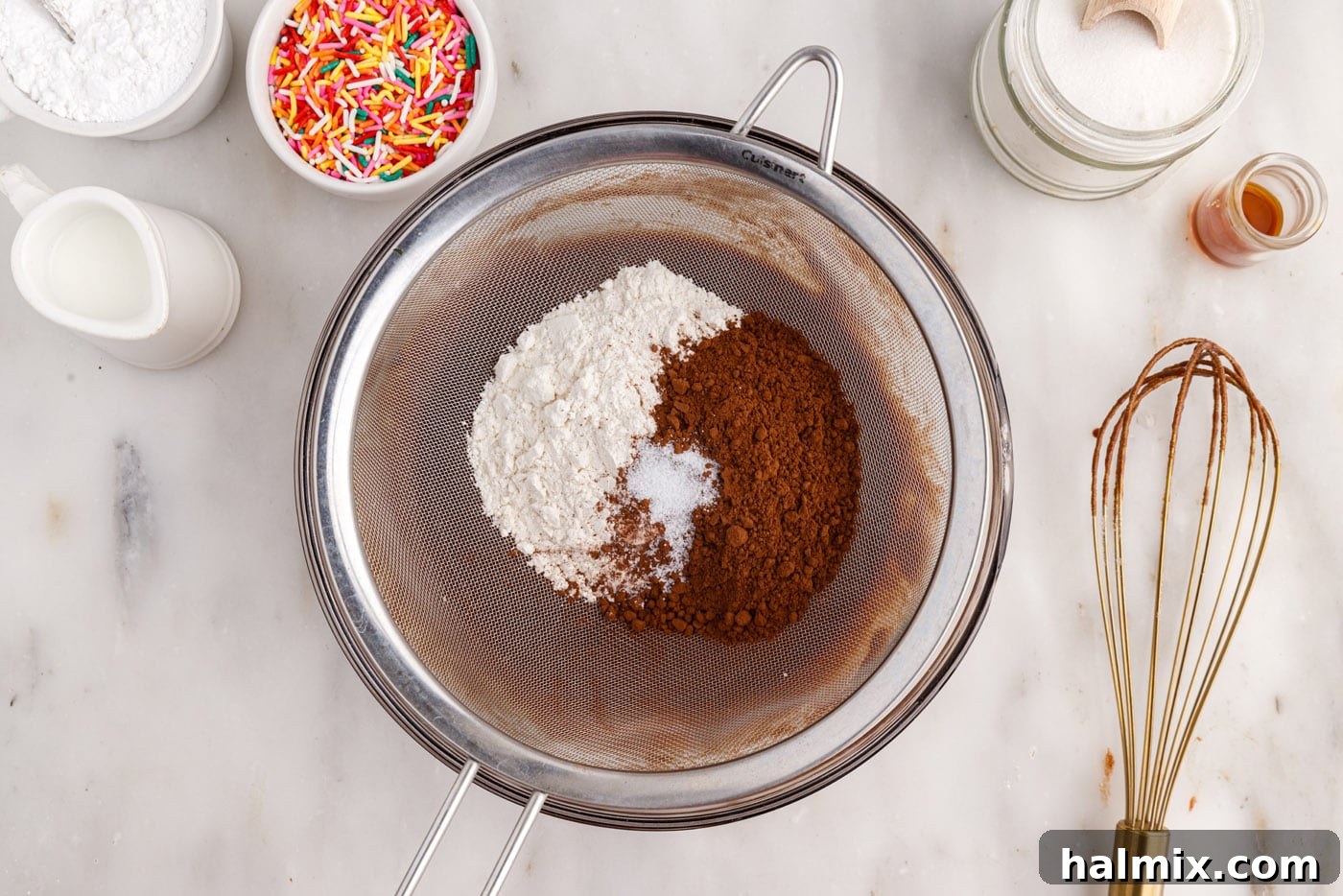 Sifting flour, salt, and cocoa powder into the bronut batter