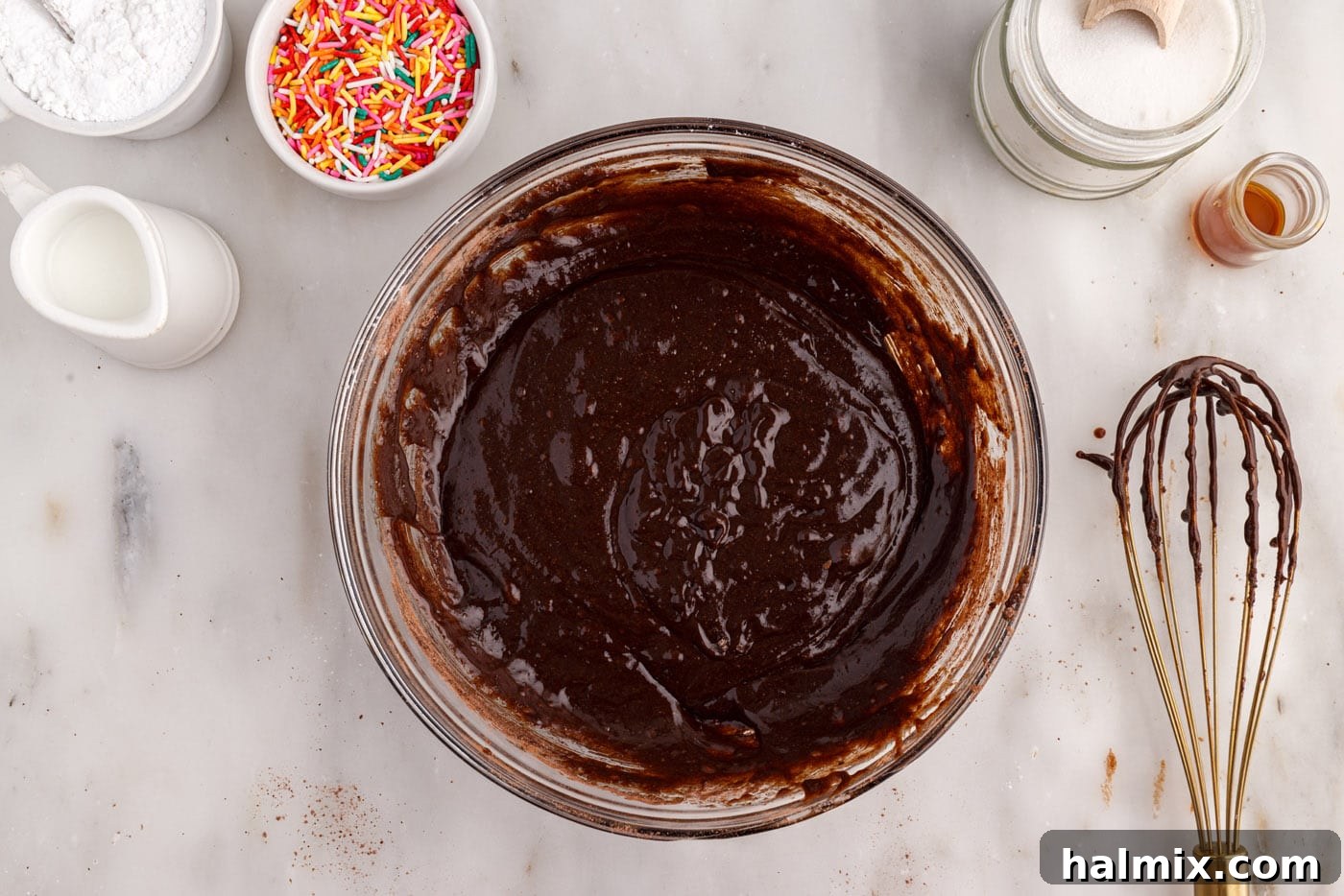 Smooth chocolate bronut batter in a mixing bowl, ready for piping