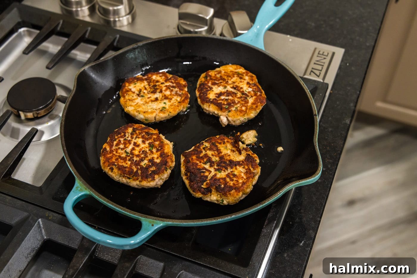salmon burgers cooked on a skillet
