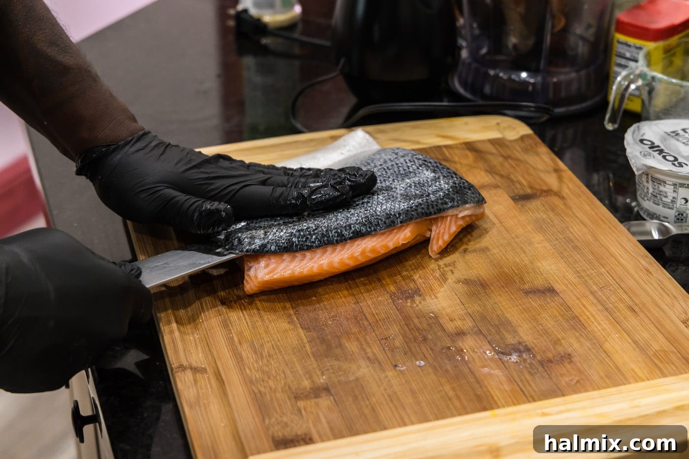 removing skin from salmon with a chef knife