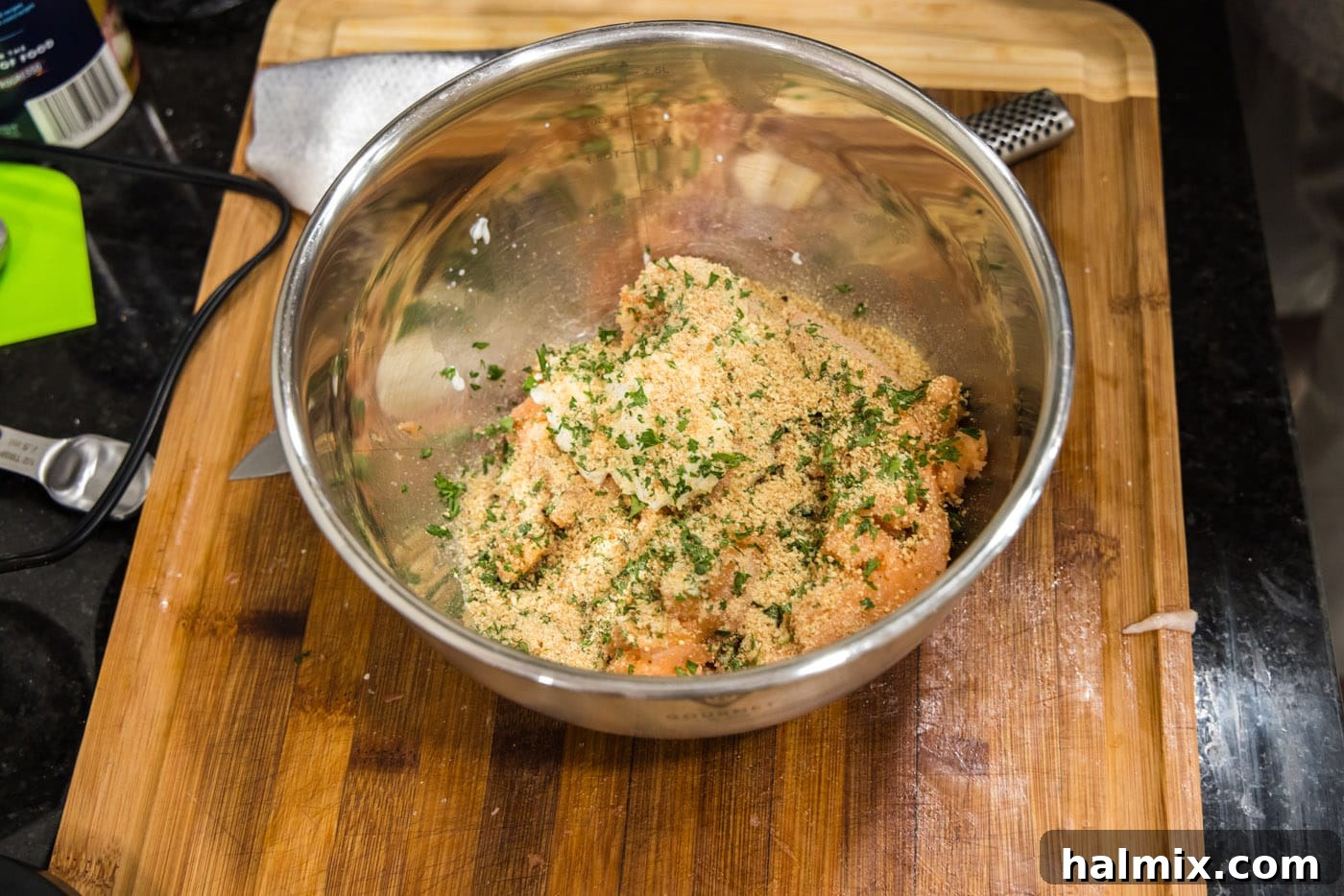 adding seasonings and herbs to salmon mixture