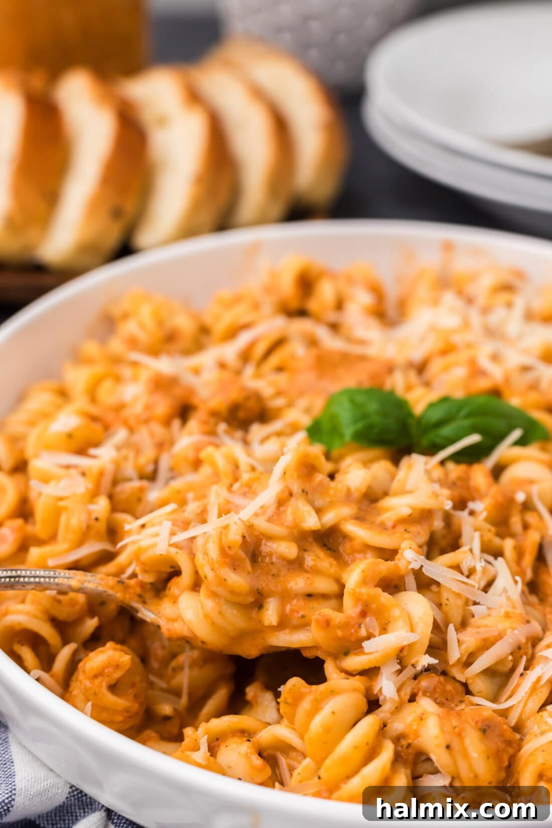 Close up photo of a spoon lifting out of a bowl of pasta covered in Vodka Sauce