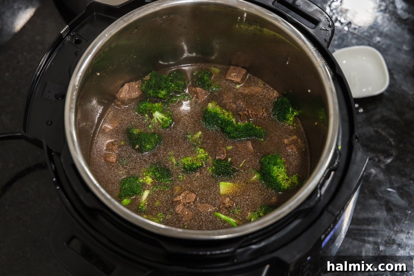 beef and broccoli mixture in the pressure cooker