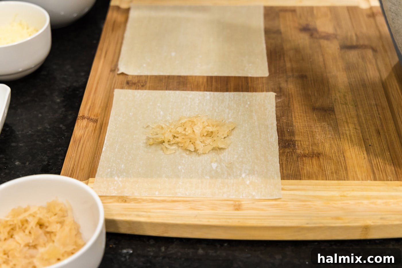 Crispy Reuben Egg Rolls 5 A single egg roll wrapper with a small mound of drained sauerkraut placed in its center, ready for additional fillings.