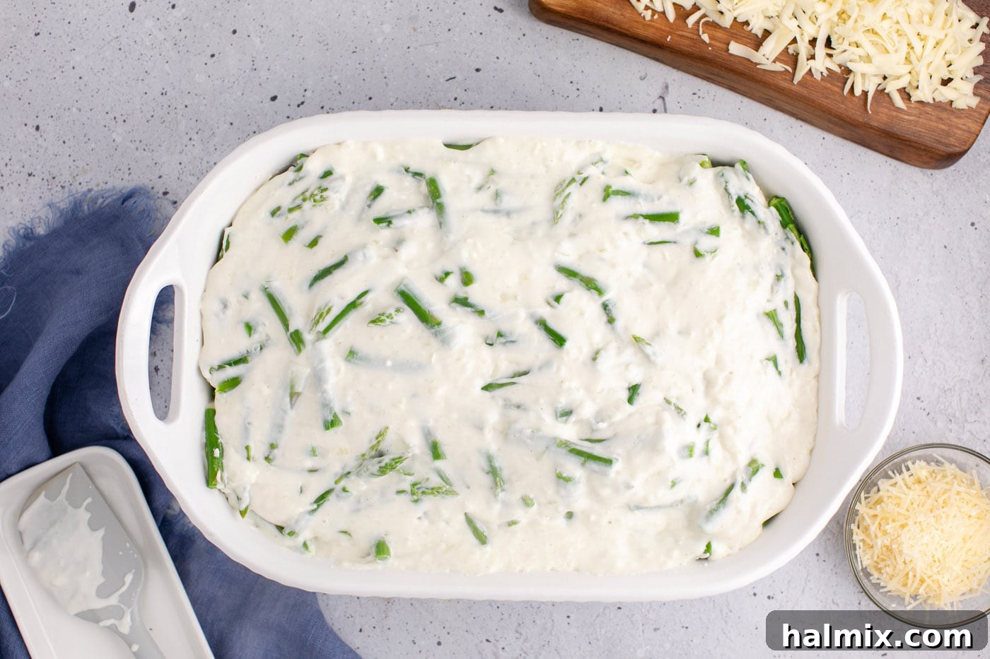 cheese sauce added to casserole dish of asparagus