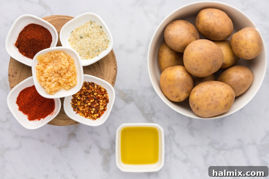 A collection of fresh ingredients laid out, including potatoes, olive oil, garlic, and various spices, ready for making spicy potatoes.