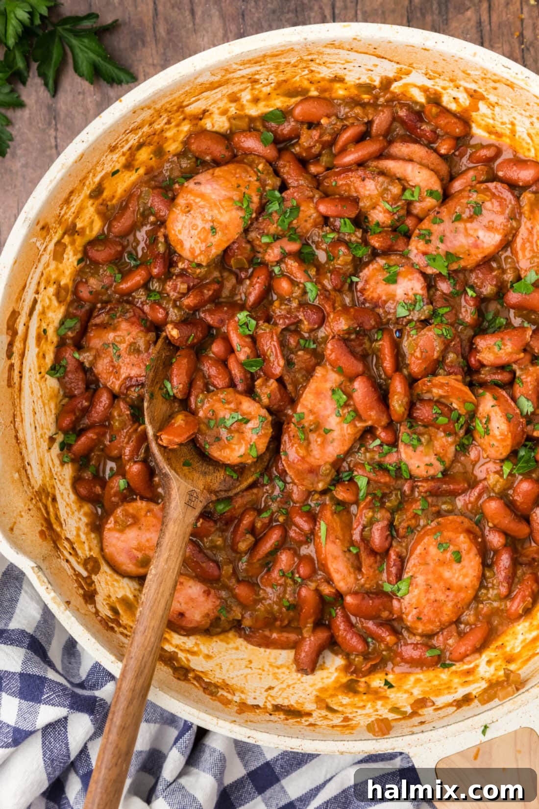 Bayou Red Beans and Rice Legacy 14 A vibrant close-up of Cajun Red Beans simmering in a cast iron skillet, showcasing the rich color and hearty texture