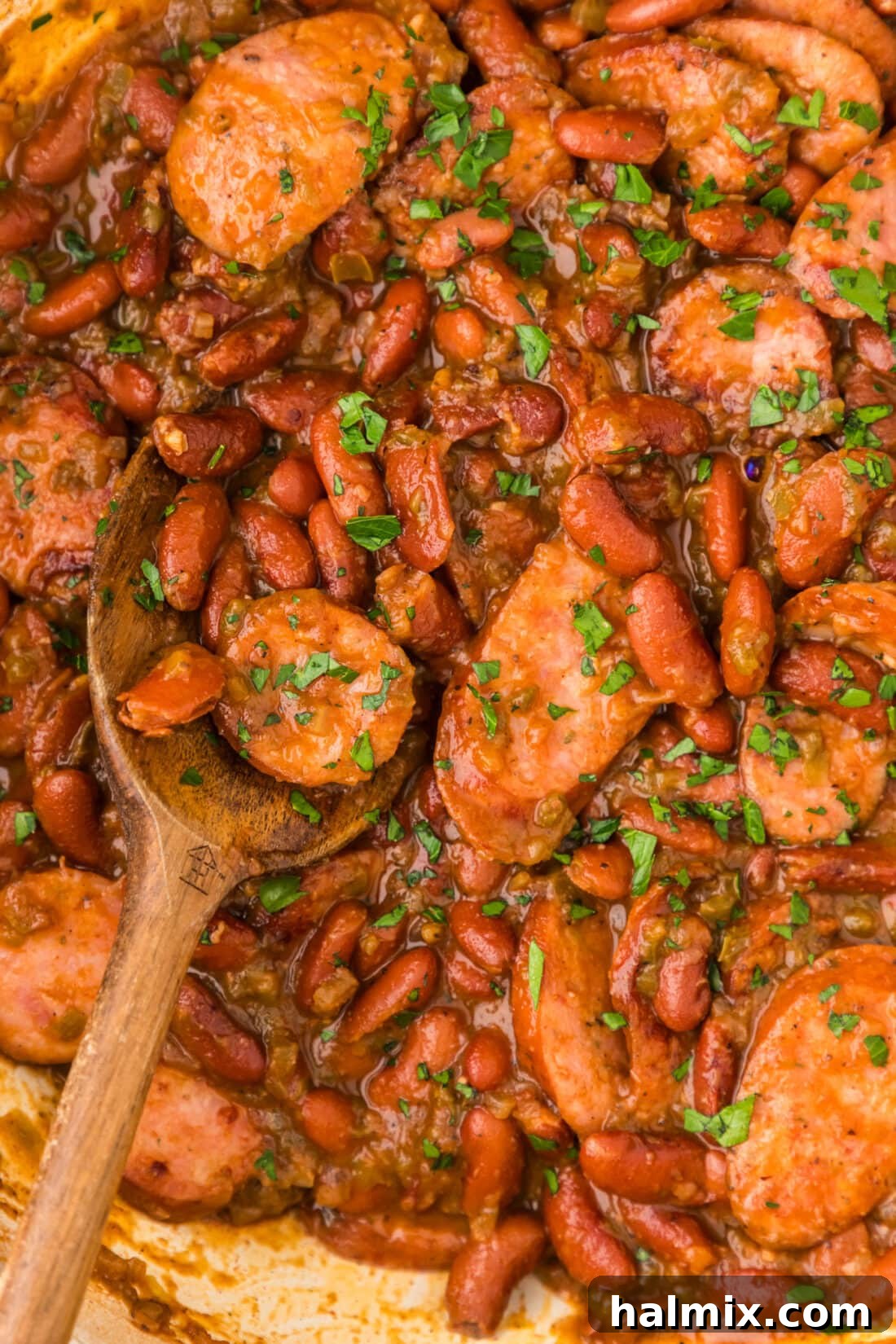 Bayou Red Beans and Rice Legacy 3 Close up photo of simmering Cajun Red Beans and Rice with smoky sausage in a large skillet, ready to be served