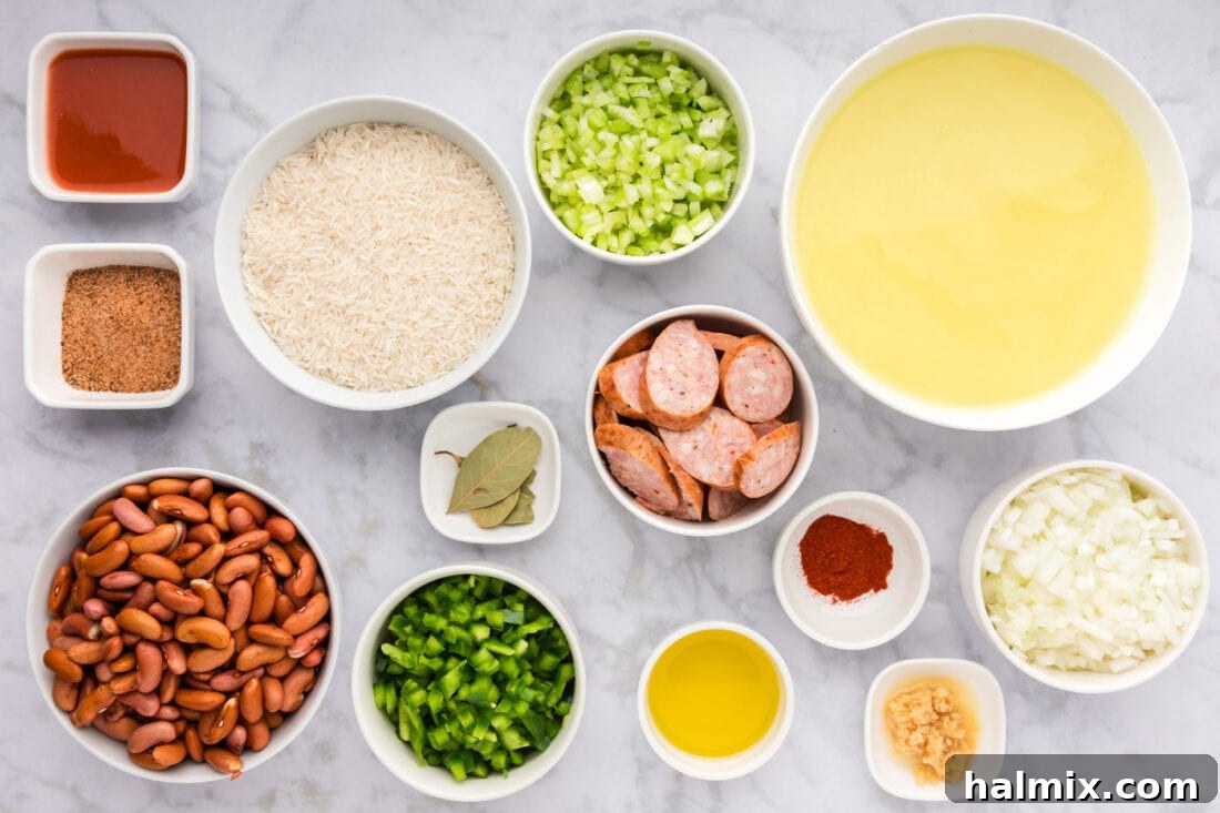 Bayou Red Beans and Rice Legacy 4 A colorful array of ingredients for Cajun Red Beans and Rice, including dried red beans, fresh vegetables, andouille sausage, and spices, laid out on a kitchen counter