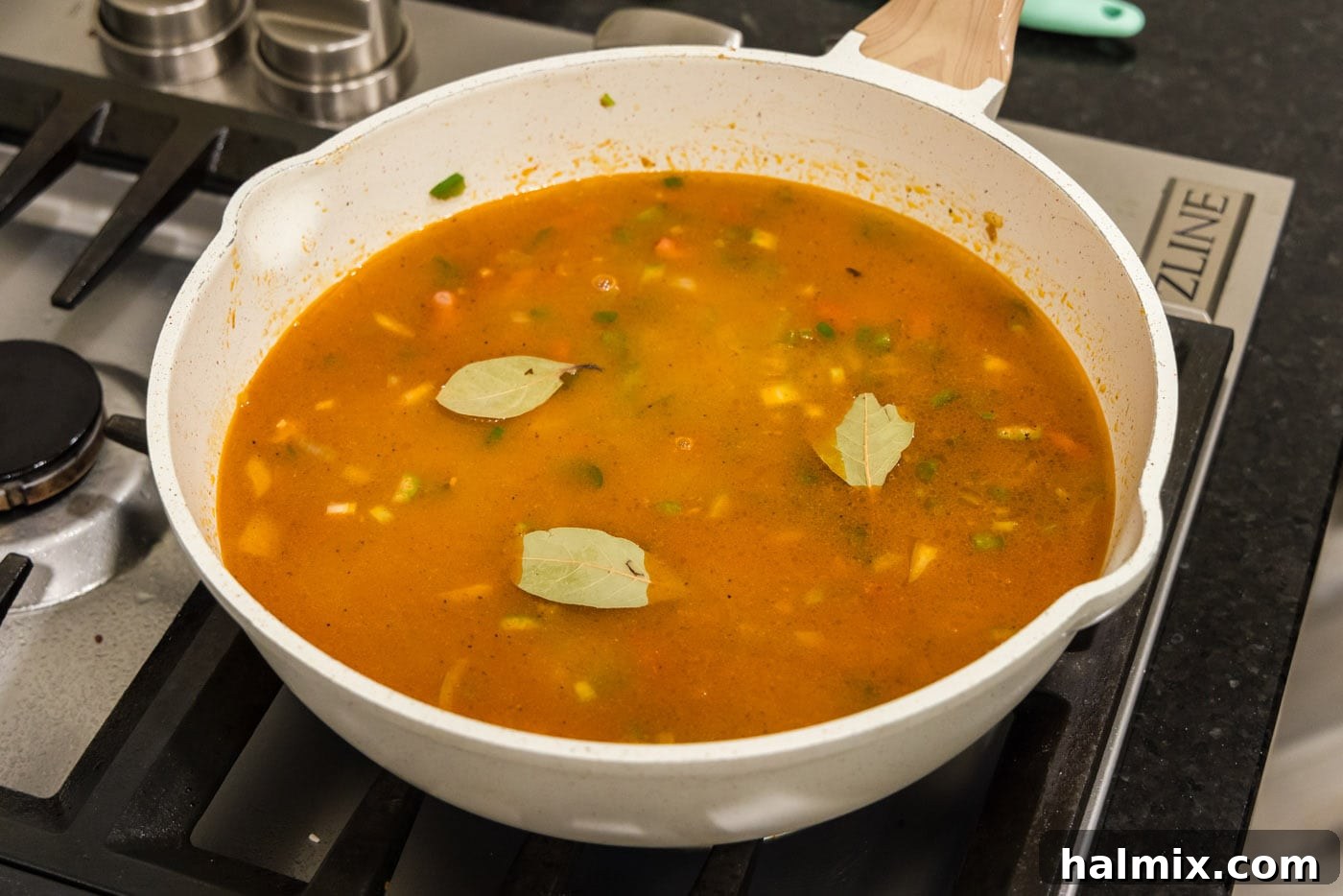 Bayou Red Beans and Rice Legacy 10 bay leaves resting on top of the red bean mixture in the skillet, ready for simmering