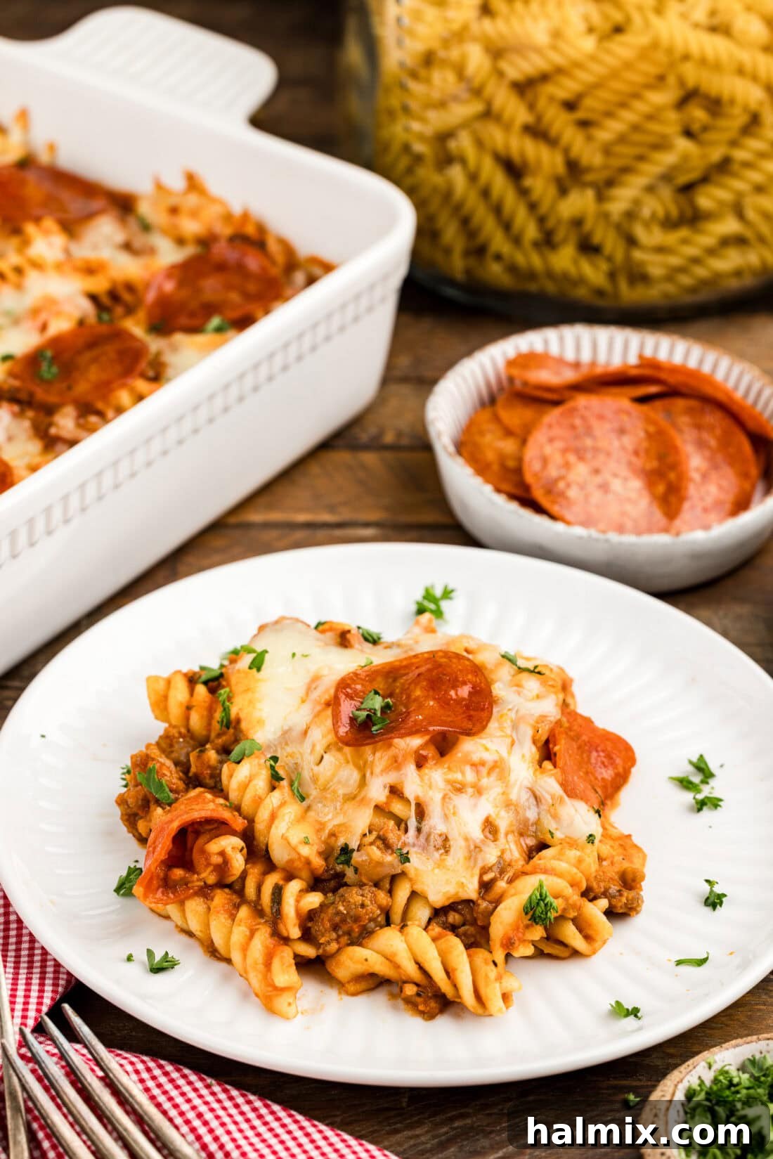 Cheesy Sausage Pepperoni Pizza Bake 11 Serving of Sausage & Pepperoni Pizza Casserole on a white plate