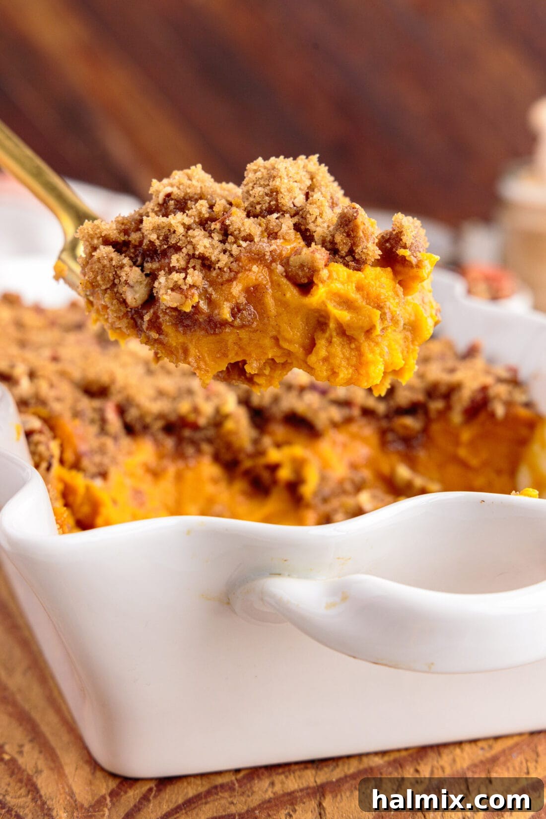 Spoonful of Sweet Potato Souffle being lifted out of the baking dish