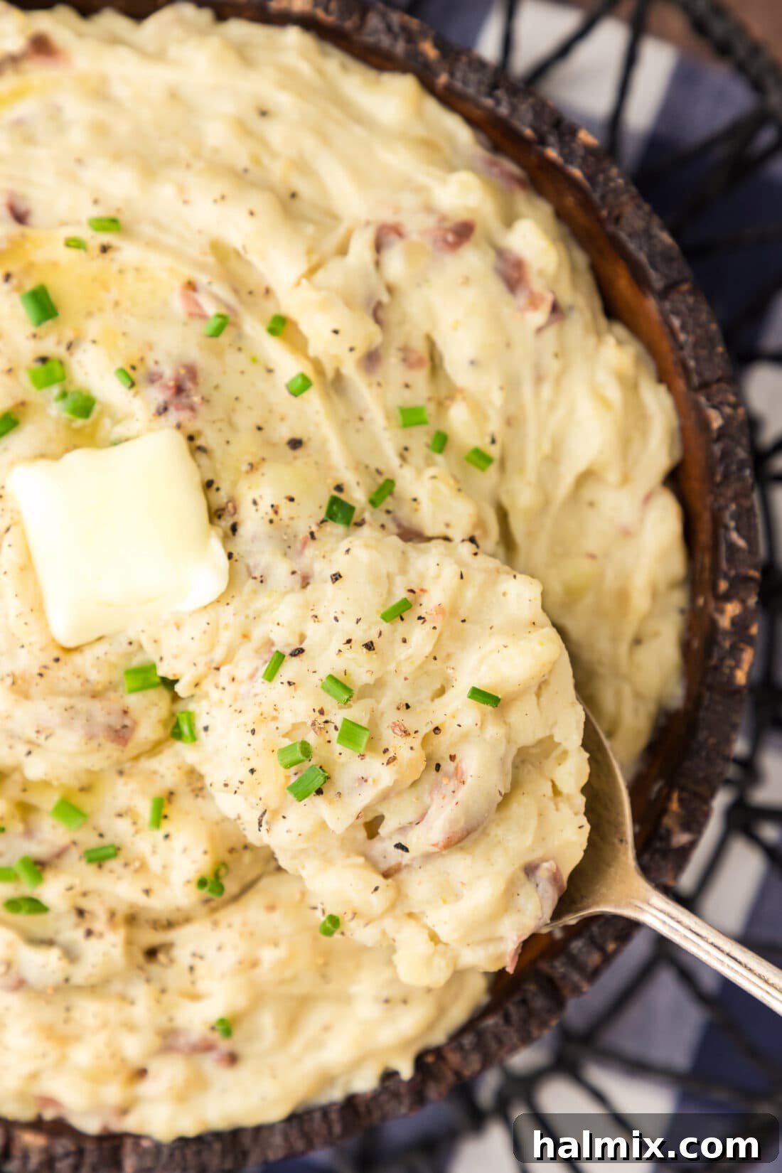Close up photo of a spoon in a bowl of Garlic Mashed Potatoes