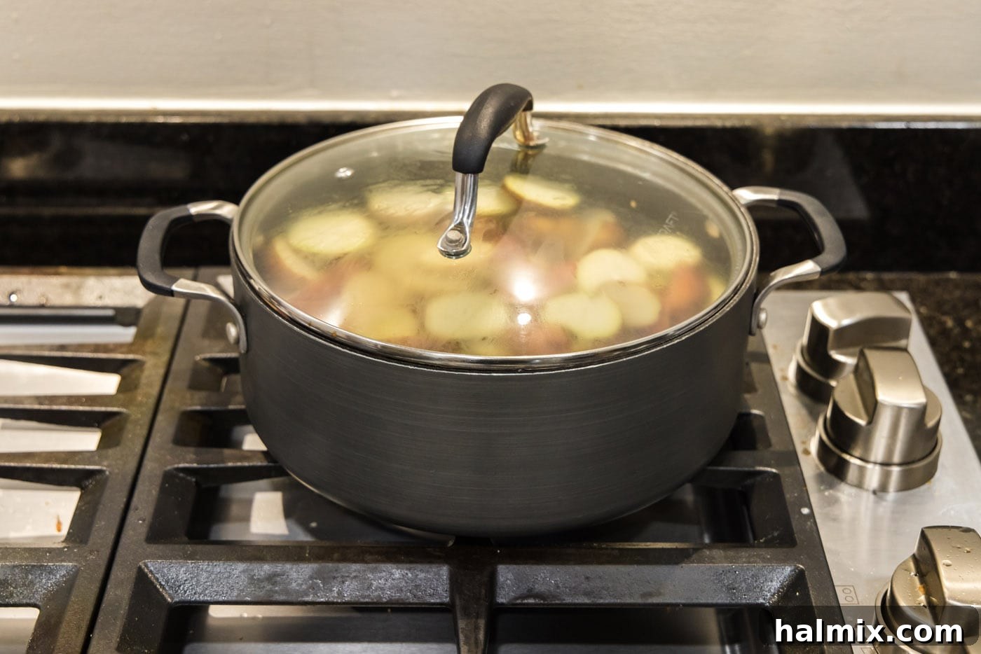 pot of red baby potatoes cooking with the lid