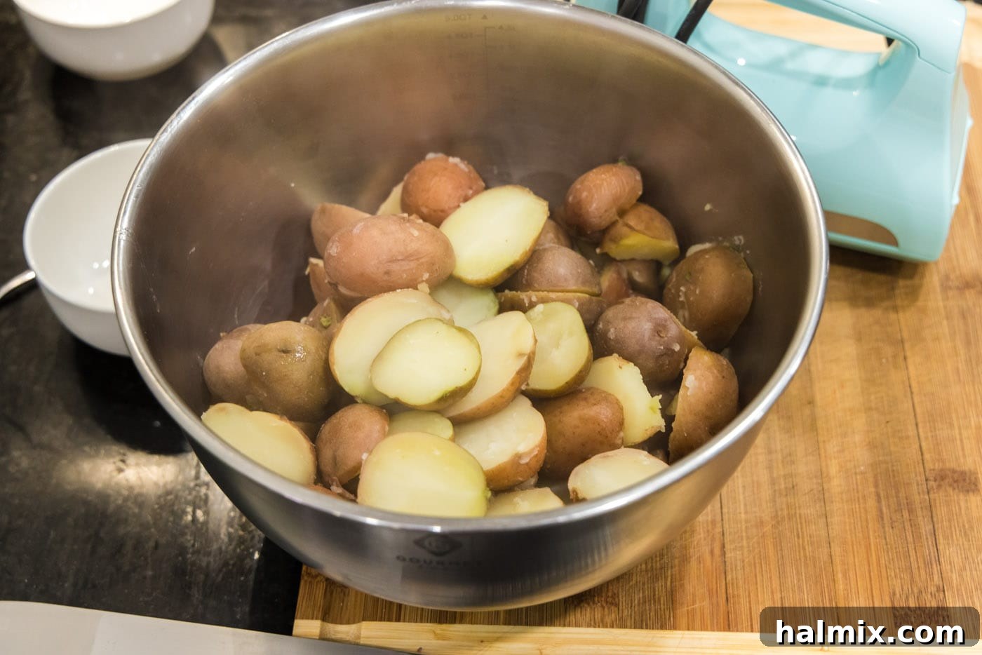 cooked sliced red potatoes in a mixing bowl