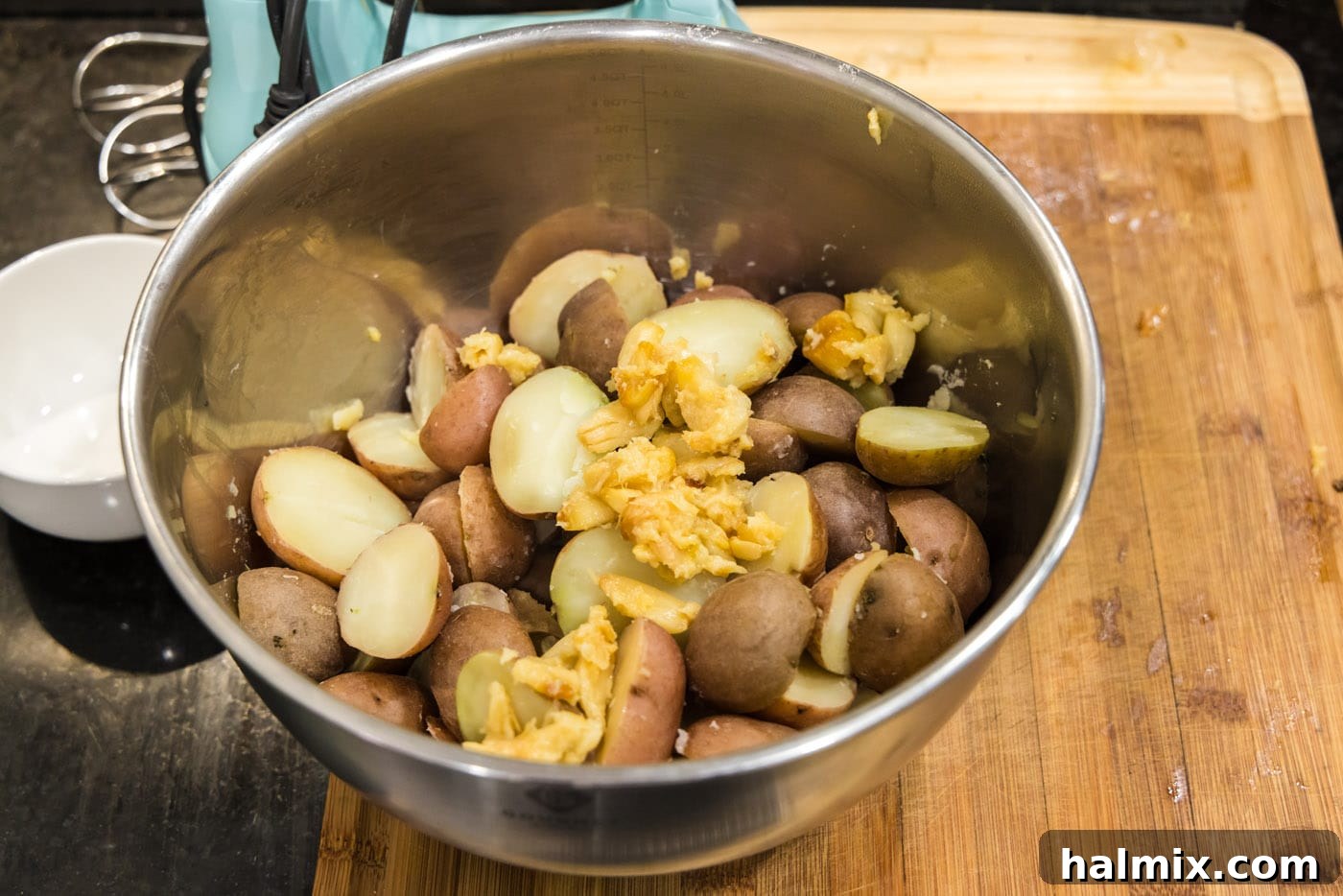 roasted garlic and baby red potatoes in a mixing bowl