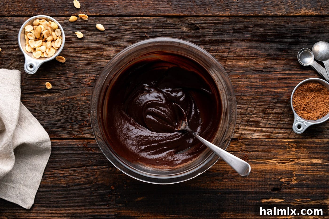 Chocolate Peanut Butter Bliss 13 chocolate ganache in a mixing bowl with a spoon