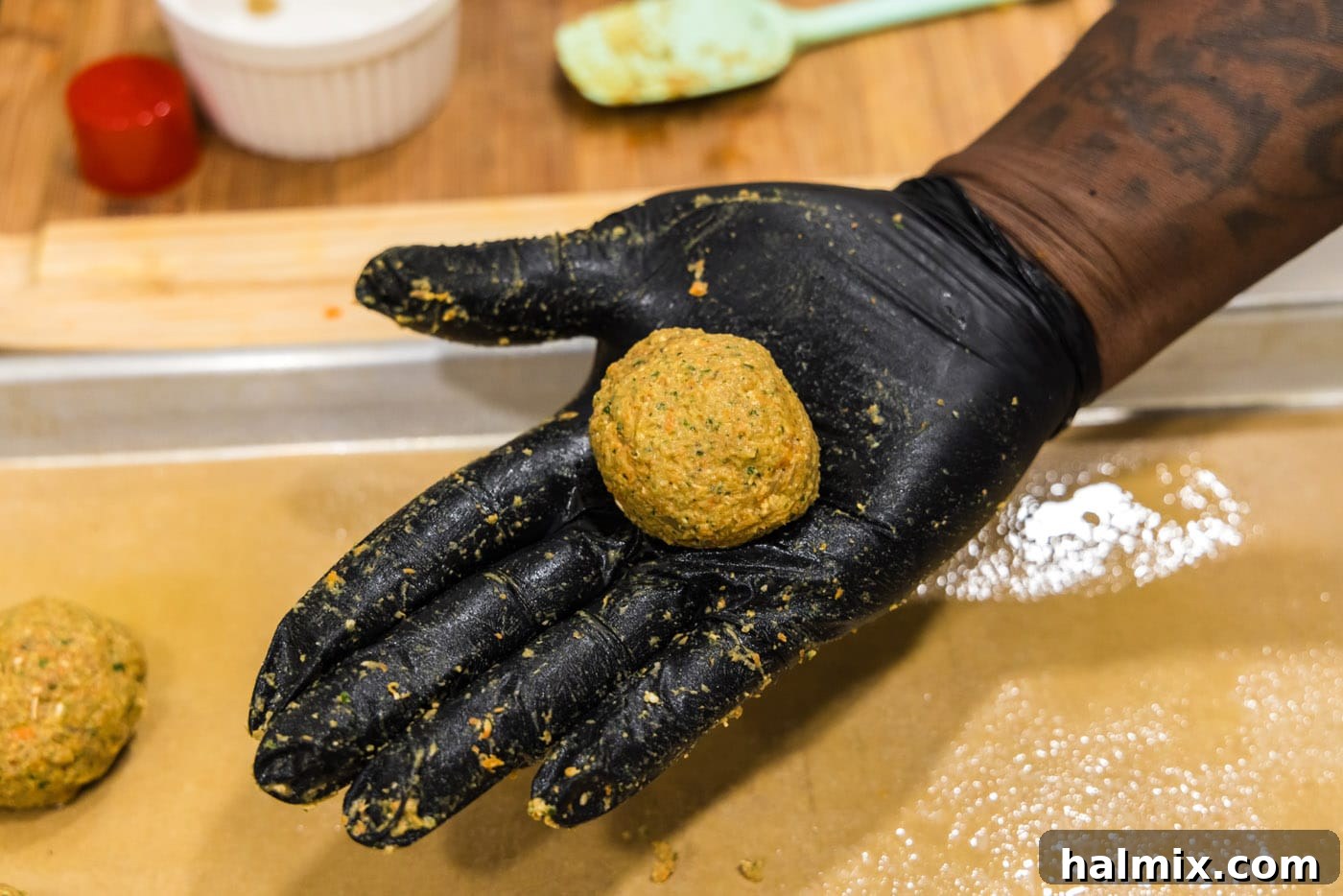 Savory Lentil Bites 11 hand holding rolled lentil meatball