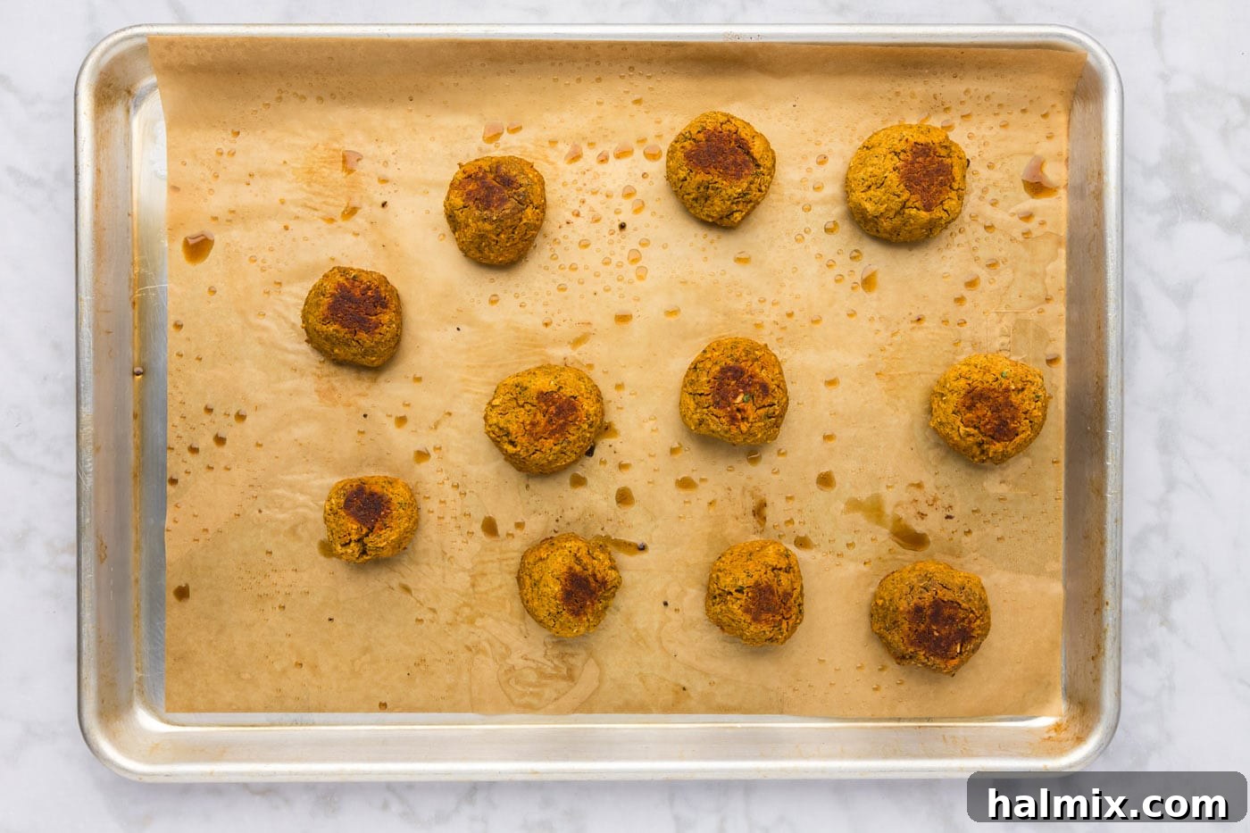 baked lentil meatballs on a cookie sheet