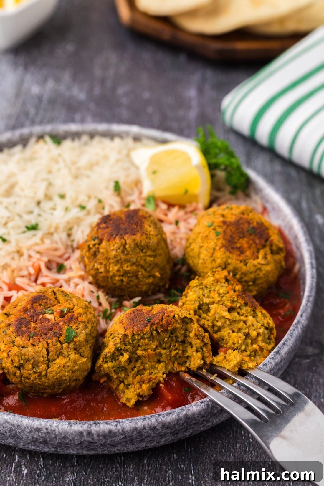 Savory Lentil Bites 3 Close up photo of a Lentil Meatball split in half with a fork