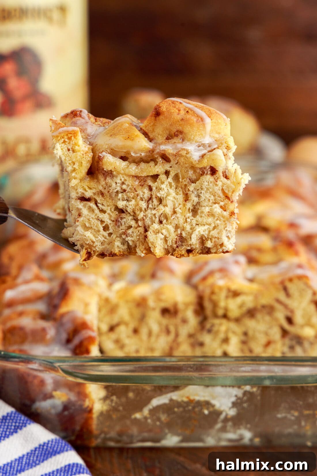 Serving of Cinnamon Roll Casserole being lifted out of the pan with a spatula