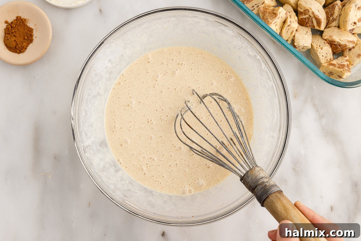 cinnamon roll filling ingredients in a bowl with a whisk