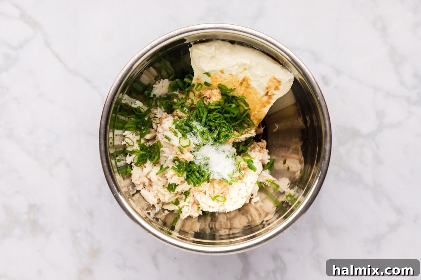 Crab rangoon filling ingredients being combined in a large mixing bowl.