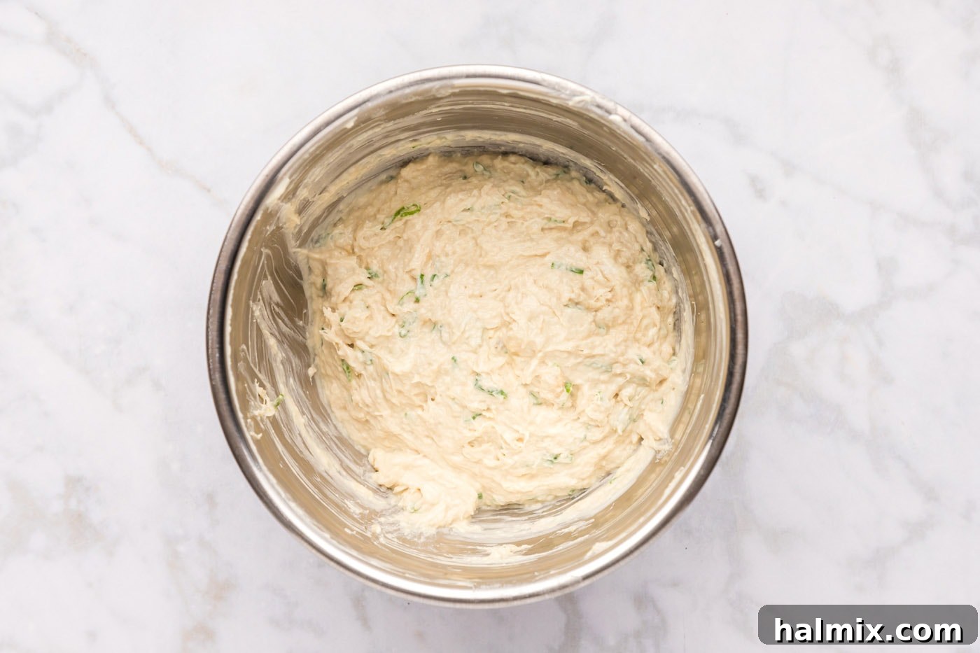Smooth, creamy crab filling for rangoons in a bowl, ready for assembly.