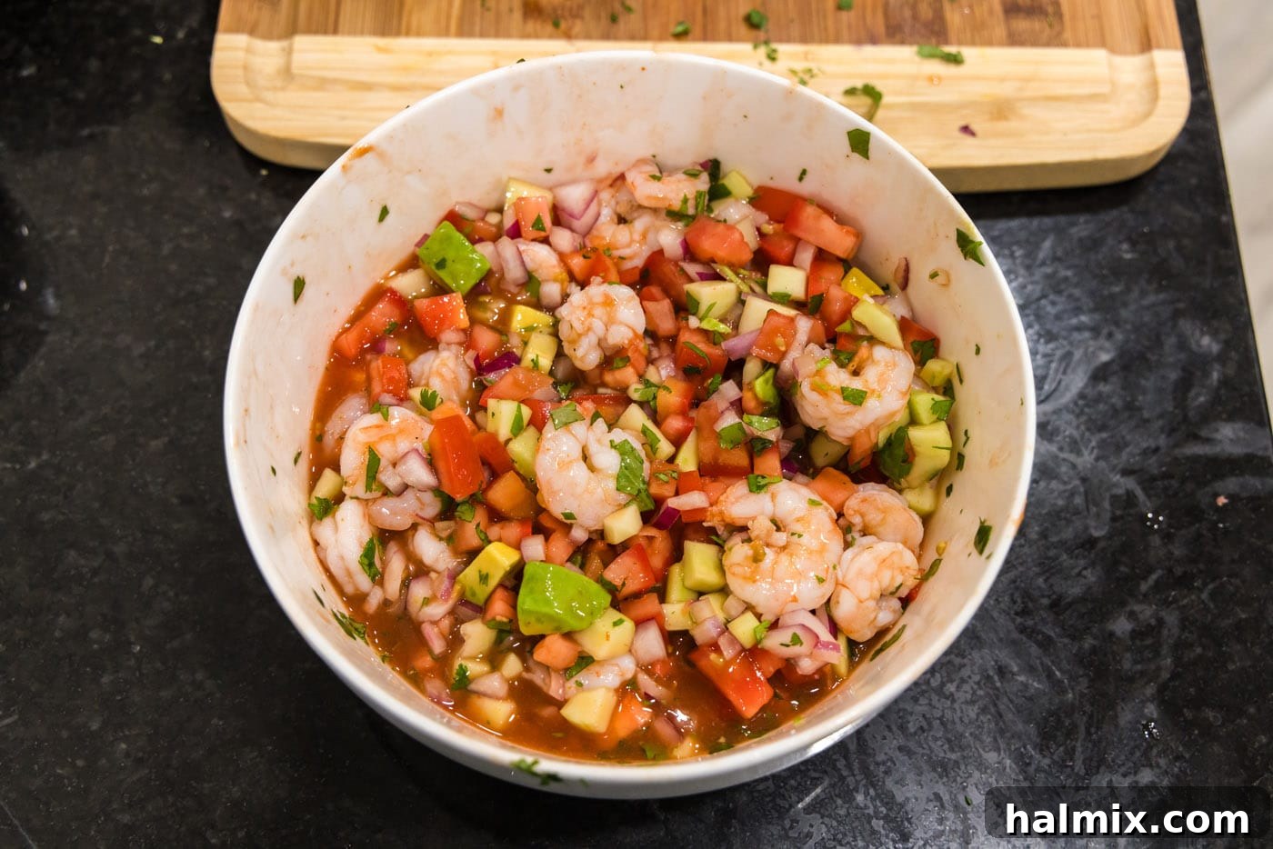 The fully combined Mexican shrimp cocktail mixture resting in a large bowl, ready to be chilled