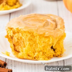 Close up photo of a Pumpkin Cinnamon Roll on a plate