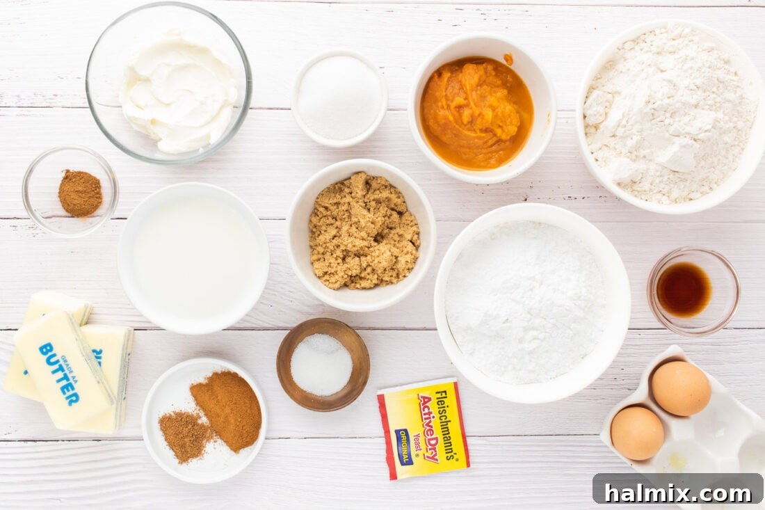 A curated selection of fresh ingredients laid out on a kitchen counter, ready for making pumpkin cinnamon rolls