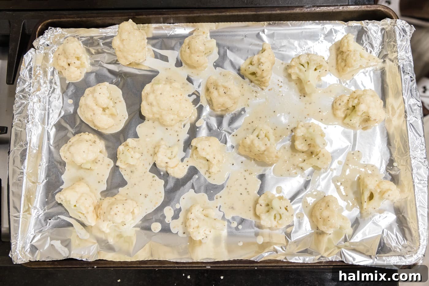 Cauliflower florets thoroughly dredged in a flour coating.